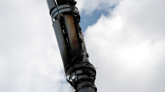 A fire-damaged telecom tower, reported in local media as being a 5G network mast, stands in Birmingham, England.