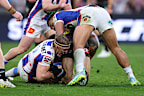 Nathan Cleary of the Panthers is tackled by Phoenix Crossland of the Knights.