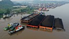 Tugboats and barges transporting coal are moored on the Mahakam River in Samarinda, East Kalimantan, Indonesia. 