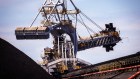 A bucket-wheel reclaimer stands next to a pile of coal. The Port of Newcastle has been wanting to diversify into containers but has been stymied.