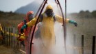 Members of the recovery team undergo decontamination after their mission. 