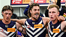 Luke Jackson, Jye Amiss and Josh Treacy sing the Fremantle song after a win.
