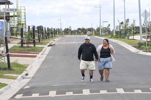 Elijah Teu (left) and Haylee Antonio  walk the streets near their new home in Mambourin.