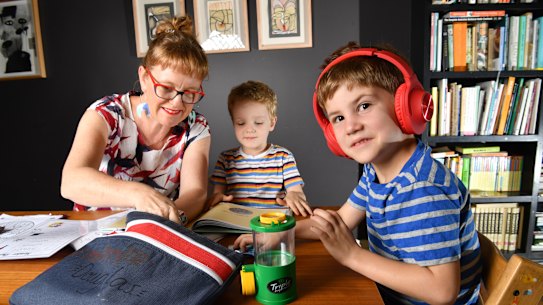 Zoe Collins is seen doing school work with her children Dare age 5 and Douglas age 7 at their home in Brisbane, Wednesday, April 15, 2020. Ms Collins will be home schooling her children for the next five weeks after the Queensland government requested parents to home school their children for the first half of Term 2, unless the parents are considered essential workers or there is no one at home who can supervise their children. (AAP Image/Darren England) 