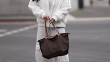 Influencer Tara Tut holding her Longchamp tote.