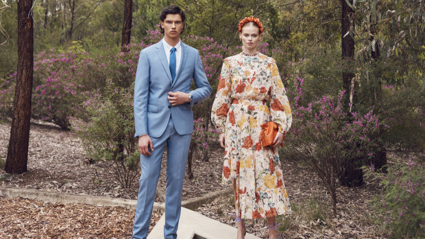 He wears Calvin Klein suit, $599, and dress shirt, $90, from David Jones; Van Heusen tie, $40; Omega “Seamaster Diver 300M 42MM” watch, $8250; R.M. Williams “Comfort Craftsman” boots, $649. She wears Kate Ford “Dahlia” blouse, $395, and skirt, $475; 
La Boheme headband, $28; Arms of Eve pearl and tiger-eye beaded necklace, $120; Loewe Flamenco clutch, $3300; Zara heels, $90.