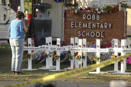 Dora Mendoza, grandmother of shooting victim Amerie Jo Garza, wipes tears from her eyes at a memorial site at Robb Elementary School.
