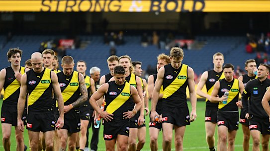 A dejected group of Tigers trudge off the MCG after Saturday’s disappointing performance against Sydney.
