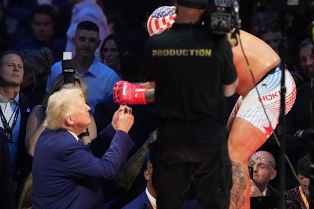 Josh Hokit presenting a necklace to Donald Trump.