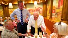 Former Prime Minister John Howard and Liberal candidate for Curtin Tom White meet local voters Helen and Les Crellin in Perth on Wednesday.