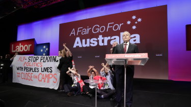 Protesters take to the stage as Bill Shorten delivers his opening address to Labor's triennial national conference.