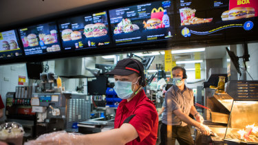 Staff at McDonald's in Boronia wearing masks on Tuesday.