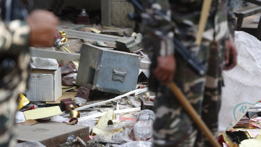 A safe of a shop lie outside after it was ransacked during riots in Delhi, India.