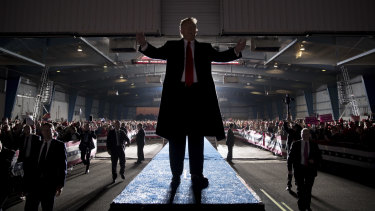 President Donald Trump gestures to the audience as he departs a rally at Southern Illinois Airport in Murphysboro, Illinois.