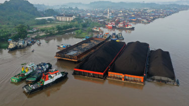 運輸煤炭的拖船和駁船停泊在印度尼西亞東加里曼丹省三馬林達的馬哈坎河上。 