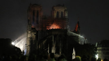 People watch Notre Dame cathedral burning in Paris. 