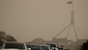 Strong winds blanket Parliament House in dust on Tuesday afternoon. 