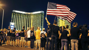 People form a human chain around the shuttered site of a country music festival where a gunman opened fire on the first anniversary of the mass shooting in Las Vegas.