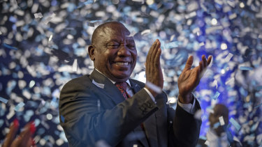 President Cyril Ramaphosa applauds as confetti is launched at the end of the results ceremony in Pretoria, South Africa.