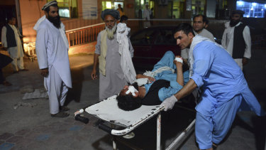 A wounded man is brought by stretcher into a hospital in Jalalabad city, capital of Nangarhar province, east of Kabul, Afghanistan, on Saturday after the bombing.