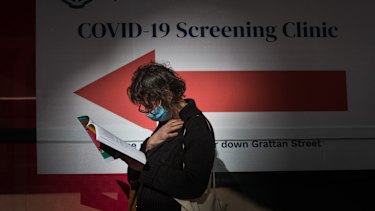 A woman waits outside a coronavirus testing station at Royal Melbourne Hospital on Thursday.