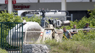 Investigators transport an Alouette II helicopter believed to have been abandoned by French prisoner Redoine Faid and suspected accomplices in July.