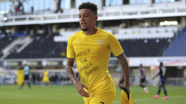 Jadon Sancho reveals a 'Justice For George Floyd' after scoring in Borussia Dortmund's 6-1 win over Paderborn.