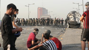 Iraqi security forces close a bridge leading to the Green Zone while anti-government protesters gather for a demonstration.