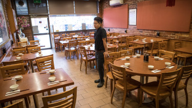 Waiter Jun Heng served five people at Dumpling King on Monday, down from as many as 40 on a regular day. 