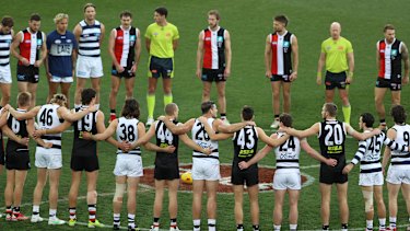 Players link arms as a stand against racism during.
