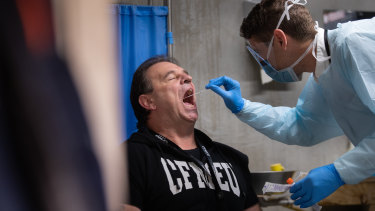 CFMEU Victorian secretary John Setka receives a coronavirus test at a mobile health bus at Multiplex Melbourne Square construction site.