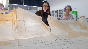 State Library of Victoria senior conservator Marika Kocsis, director of collections Jo Ritale and conservation manager Jane Hinwood  with the original drawings of St Paul’s Cathedral.