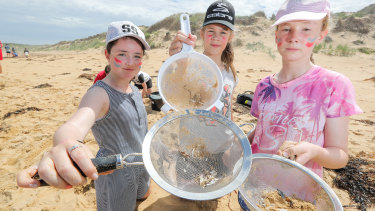 Terang College students Gemma, Abbey and Charlotte collect nurdles on Second Beach, Warrnambool.