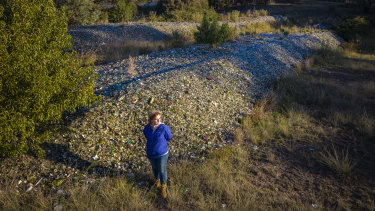 Caitlin Miller with about 900 tonnes of glass she says was dumped on her Bywong property by her father, Garry Miller, without permission. 