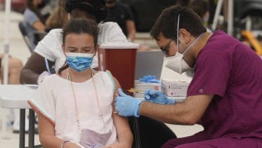 Francesca Anacleto, 12, receives her first Pfizer COVID-19 vaccine shot in Miami Beach, Florida on Tuesday. The state has seen an eight-fold increase in cases since July 4.