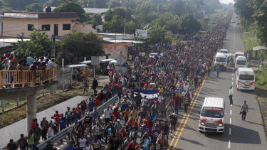 Central American migrants walking to the US start their day departing Ciudad Hidalgo, Mexico, on Sunday.