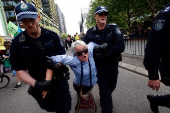 Police drag away a protester in Sydney on October 7. 