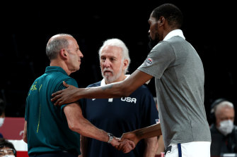 Kevin Durant and Gregg Popovich shake hands with Boomers coach Brian Goorjian.