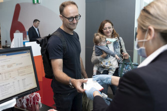 Passengers check-in for their flight to Adelaide on Thursday. 