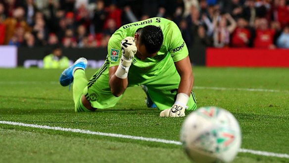 United's Sergio Romero celebrates a penalty save.