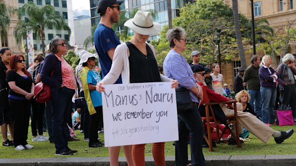 Supporters were holding placards while bowing their heads as they heard stories of refugees.