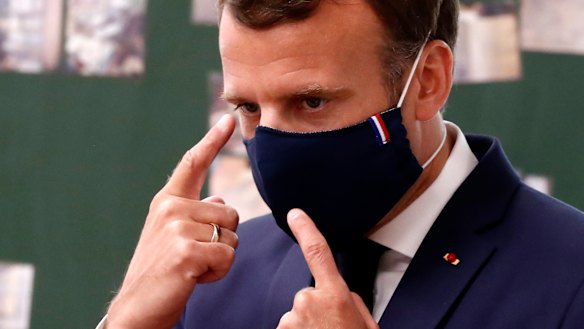 French first: President Emmanuel Macron wear a made-in-France mask while visiting a school. 