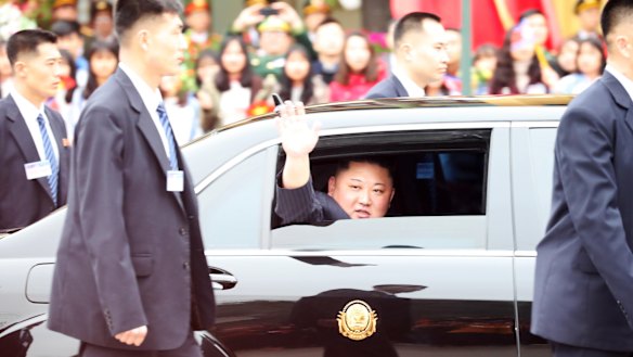 North Korean leader Kim Jong-un waves as his motorcade leaves Vietnam's Dong Dang Station for Hanoi on Tuesday.