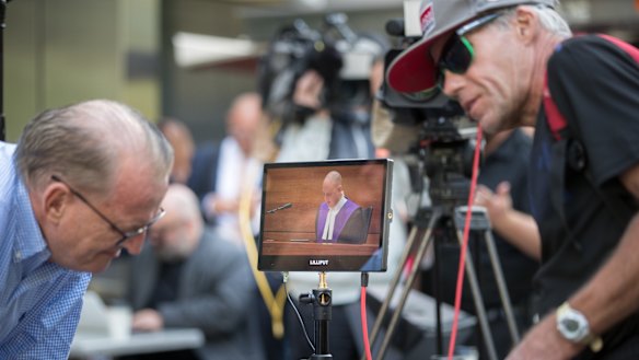 Michael Advocate (left) listens to the sentencing outside of court. 