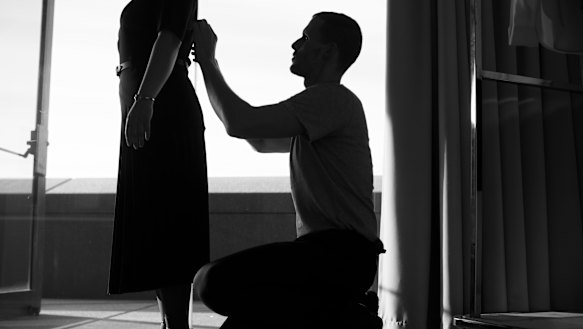 Dion Lee fine-tunes the Opera House uniforms using a staff member as his model.