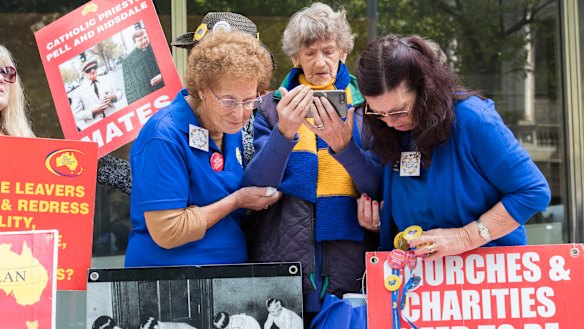 They huddled around mobile phones outside the court as the sentence was broadcast live.