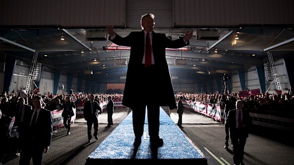President Donald Trump gestures to the audience as he departs a rally at Southern Illinois Airport in Murphysboro, Illinois.