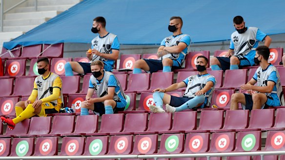 Sydney FC’s substitutes sit in the stands, socially distanced, at Doha’s Khalifa International Stadium late last year.