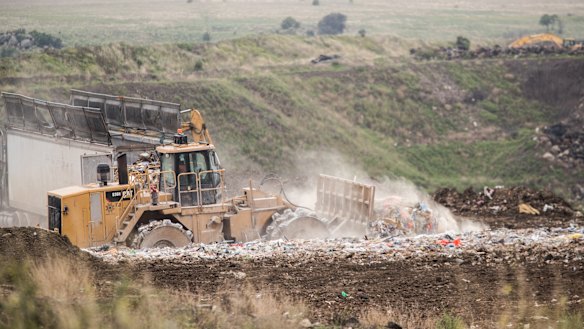 Trucks moving the burning waste back in February 2020.