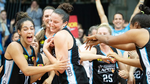 Canberra Capitals teammates cheer their co-captain Kelsey Griffin